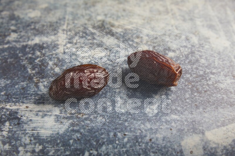 two madjoul dates on a rustic blue backround
