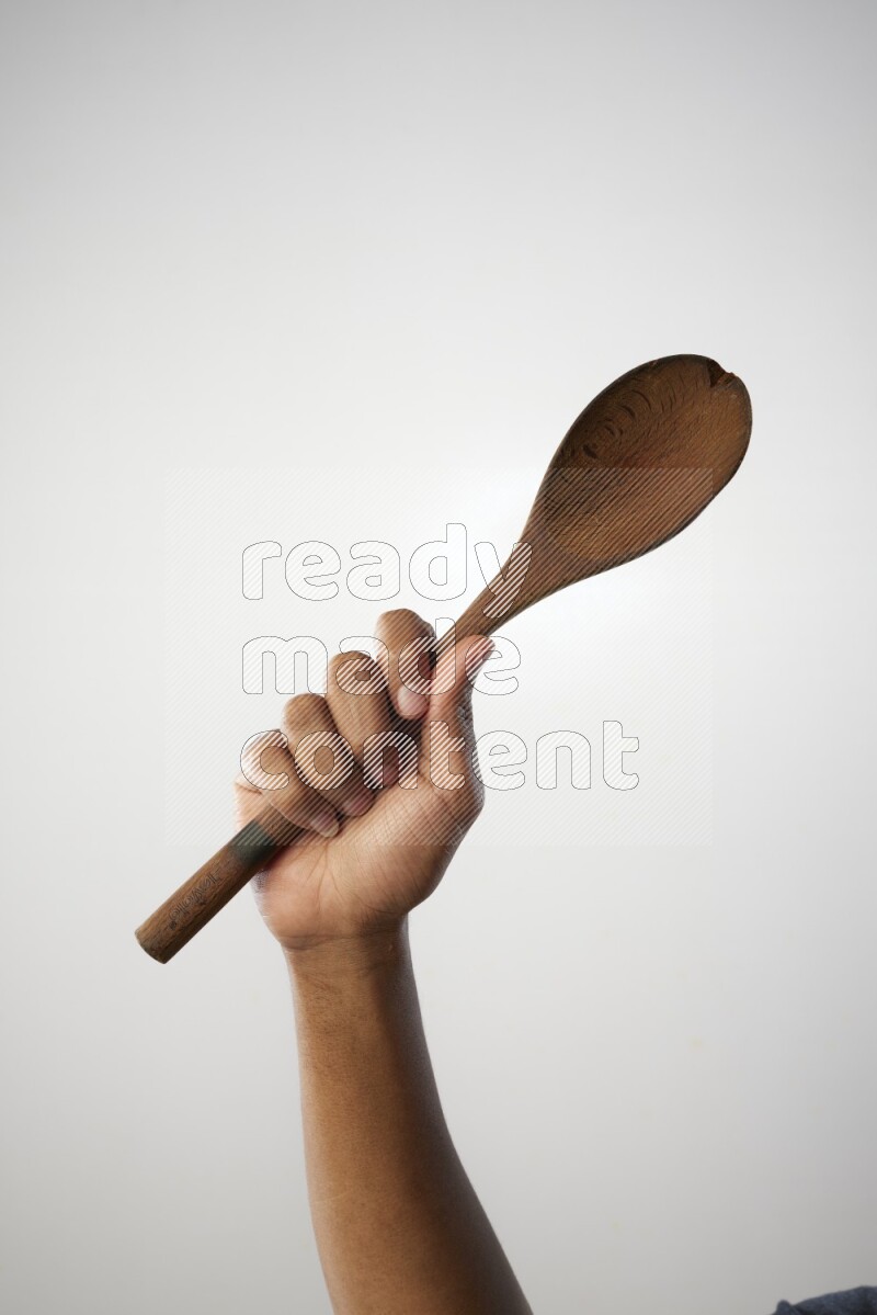 Male Hand Holding Wooden spoon on white background