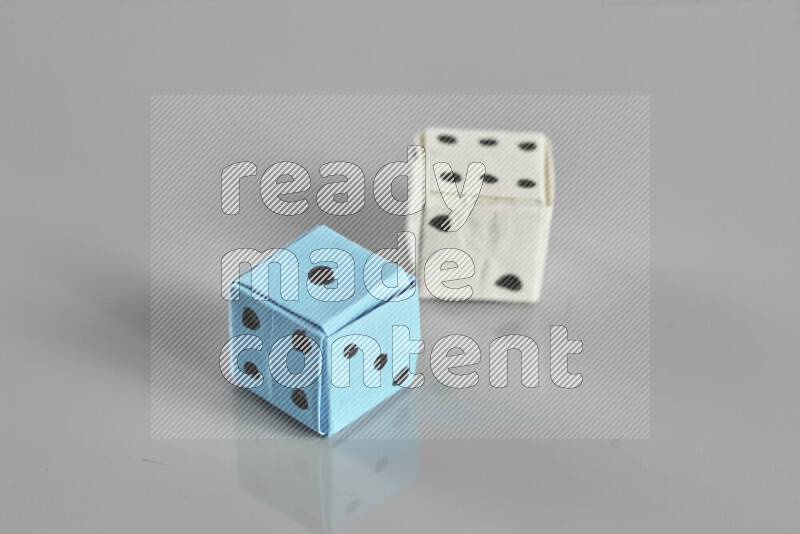 Origami dice on grey background