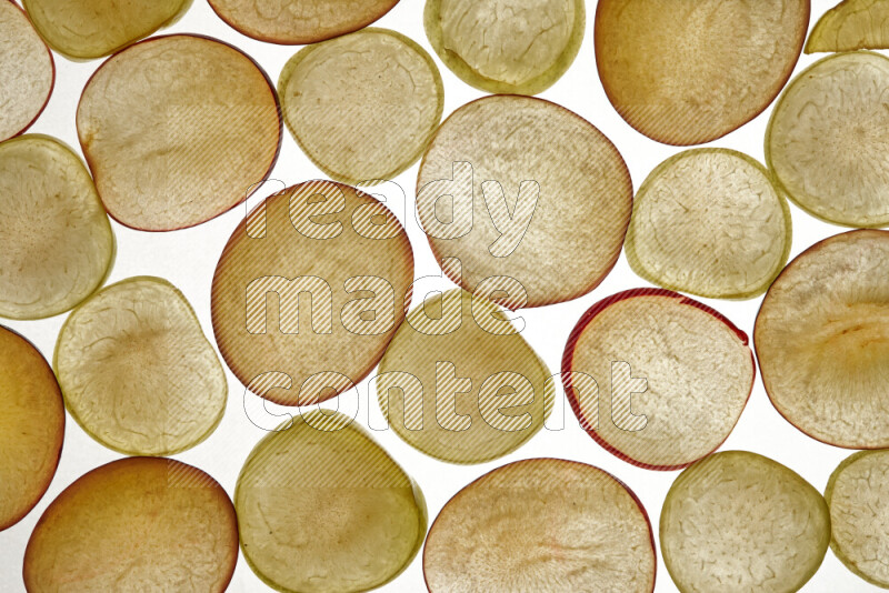 Plum slices on illuminated white background