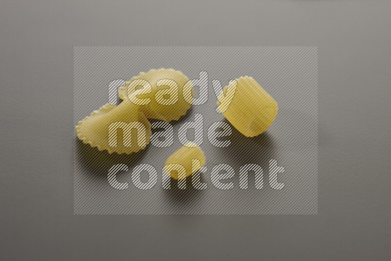 Different pasta types on grey background