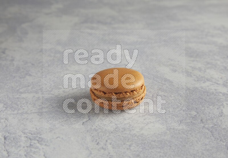 45º Shot of Brown Maple Taffy macaron on white  marble background