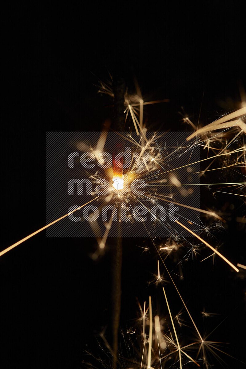 A close-up image of sparkler candle isolated on black background