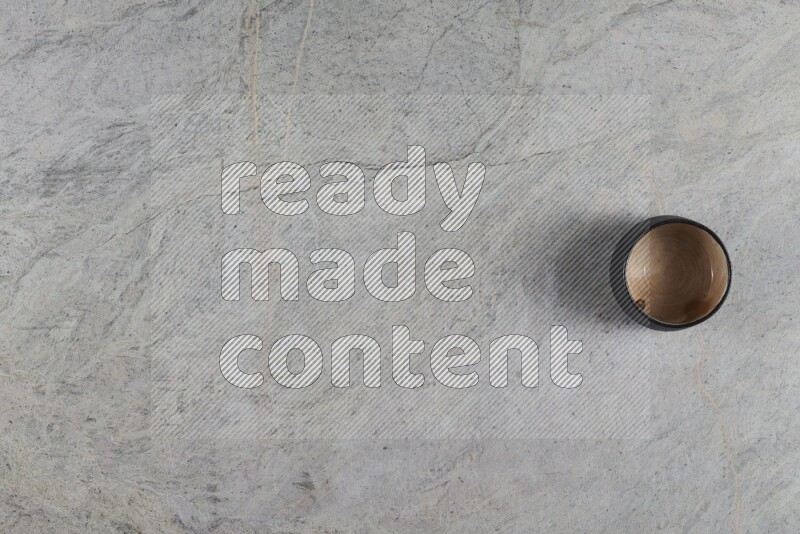 A multicolored pottery Bowl on grey marble background