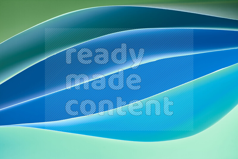 This image showcases an abstract paper art composition with paper curves in green and blue gradients created by colored light
