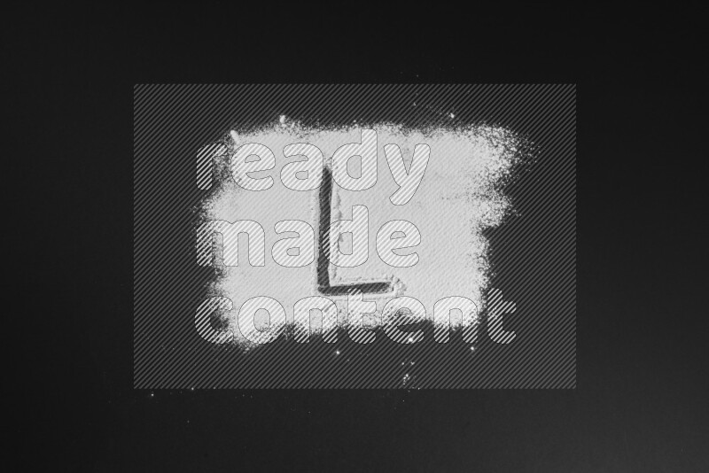 Alphabets written with powder on black background