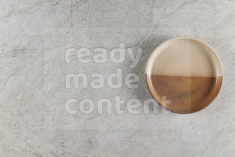 A multicolored pottery oven bowl on grey marble background