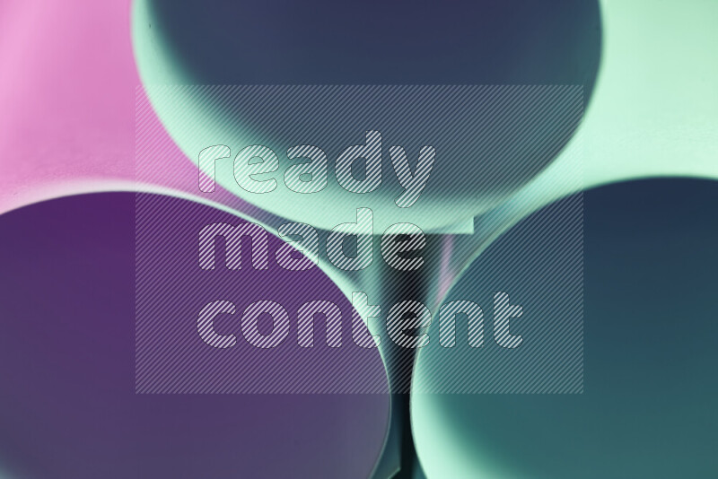 The image shows an abstract paper art with circular shapes in varying shades of green and purple