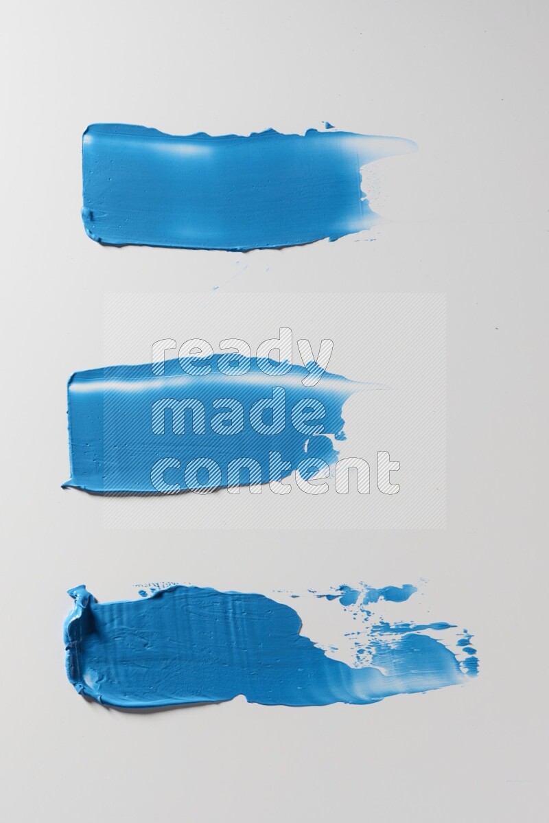 Blue painting knife strokes on a white background