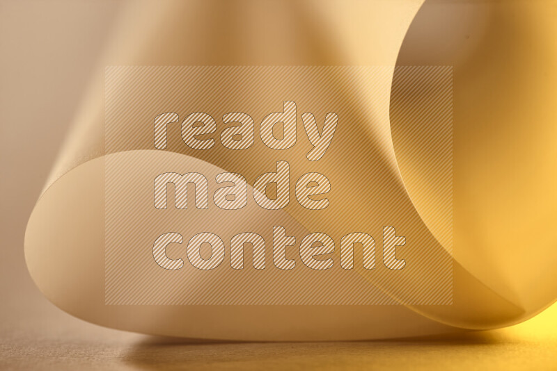 An abstract art piece displaying smooth curves in gold gradients created by colored light