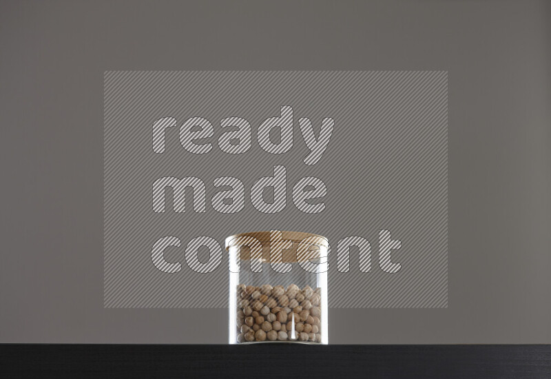 Chickpeas in a glass jar on black background
