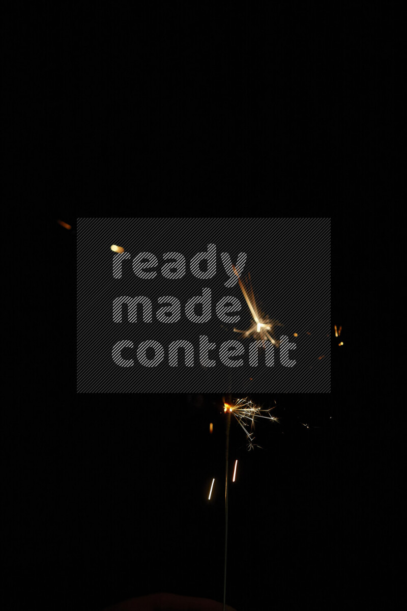 A close-up image of sparkler candle isolated on black background