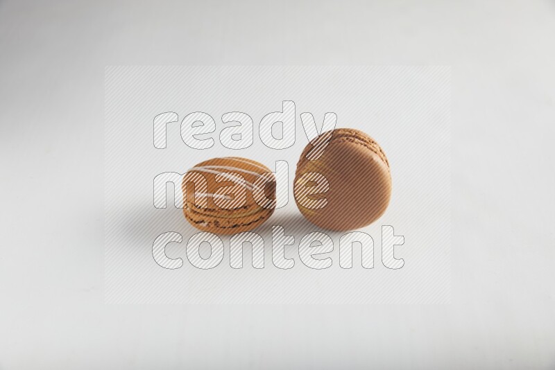45º Shot of of two assorted Brown Irish Cream, and Brown Coffee macarons  on white background