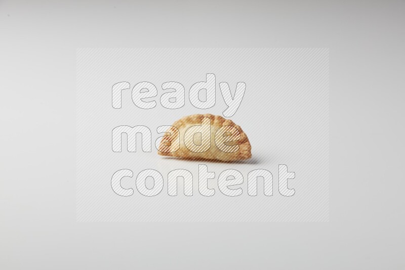 One fried sambosa on a white background