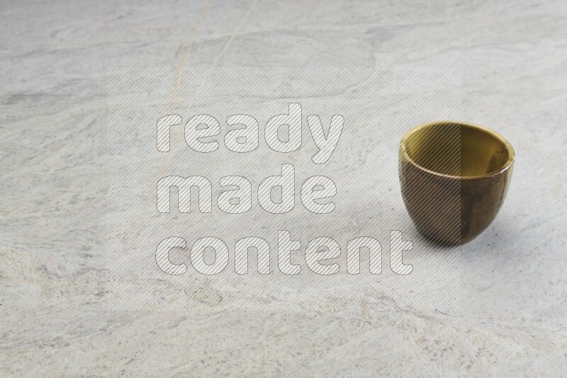 A multicolored pottery Cup on grey marble background
