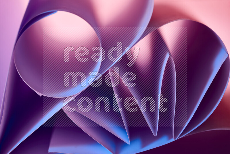 An artistic display of paper folds creating a harmonious blend of geometric shapes, highlighted by soft lighting in purple tones