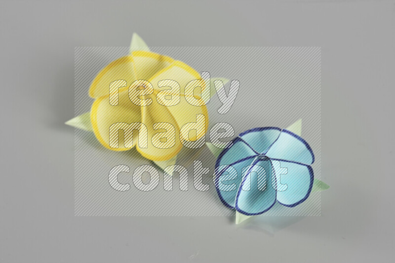 Origami flower on grey background