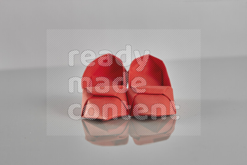 Origami shoes on grey background