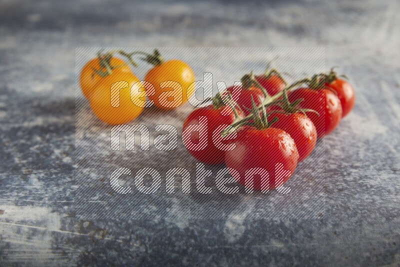 Mixed cherry tomato veins on a textured rustic blue background 45 degree
