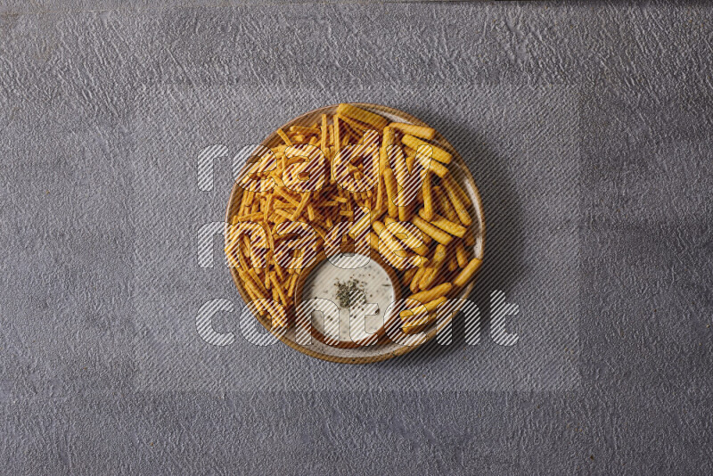 Assorted snacks in pottery bowls on grey background