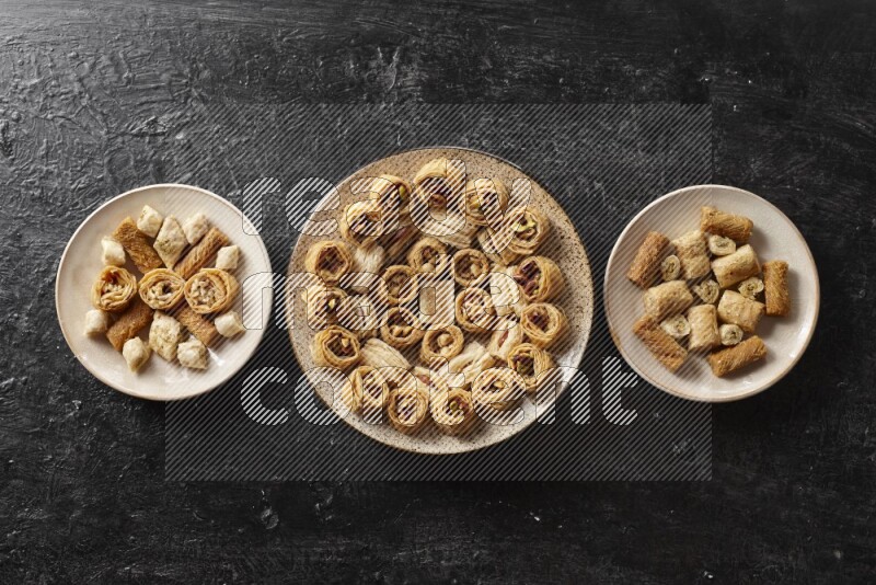 Oriental sweets in pottery plates in a dark setup