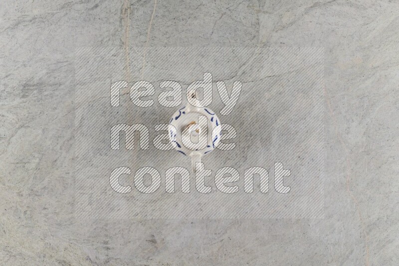 A pottery teapot on grey marble background