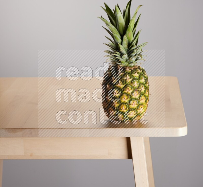 pineapple on the edge of wooden table
