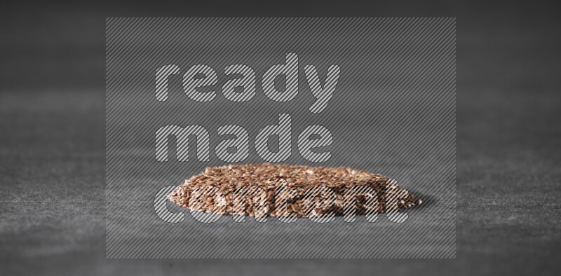 Flax Seeds in a circle shape on a black Flooring