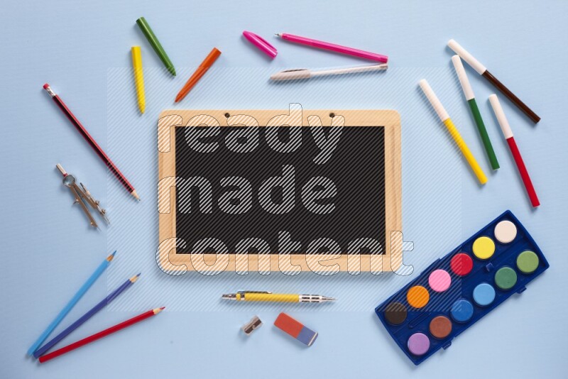 A blackboard with assorted school supplies on blue background