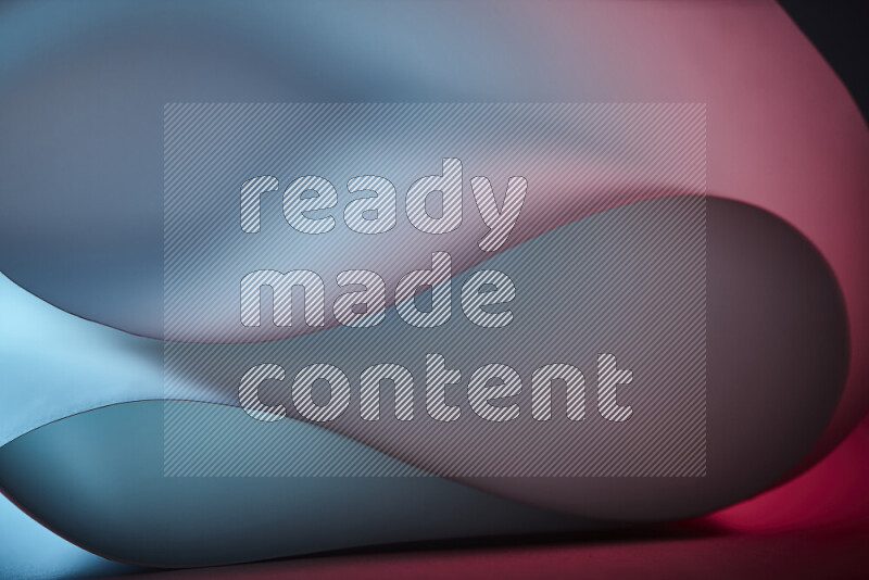 An abstract art piece displaying smooth curves in blue and red gradients created by colored light