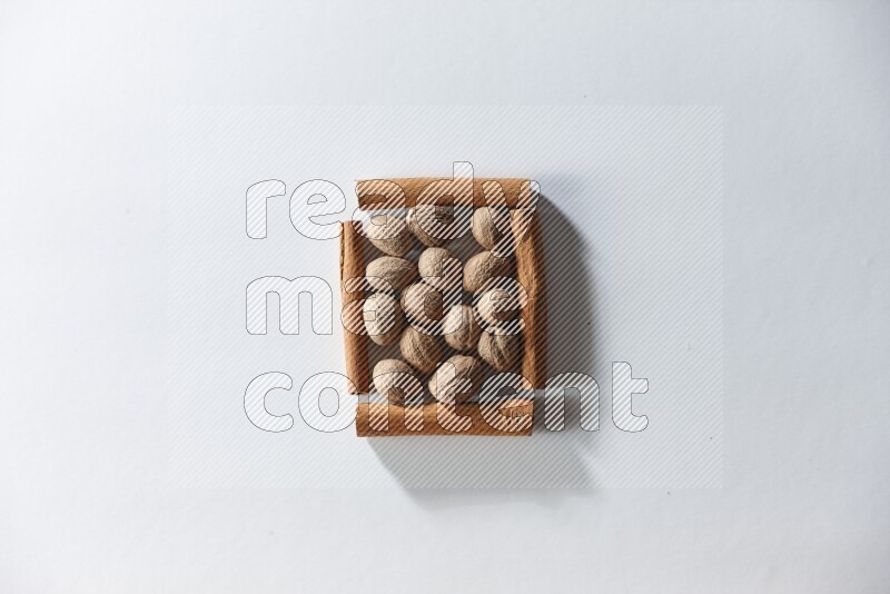 A single square of cinnamon sticks full of nutmeg on white flooring
