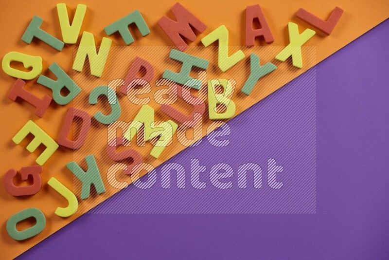 Colorful foam alphabets letters for kids on orange and purple background (kids toys)