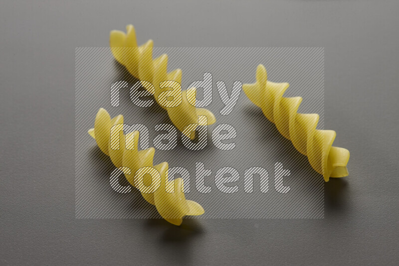 Fusilli pasta on grey background