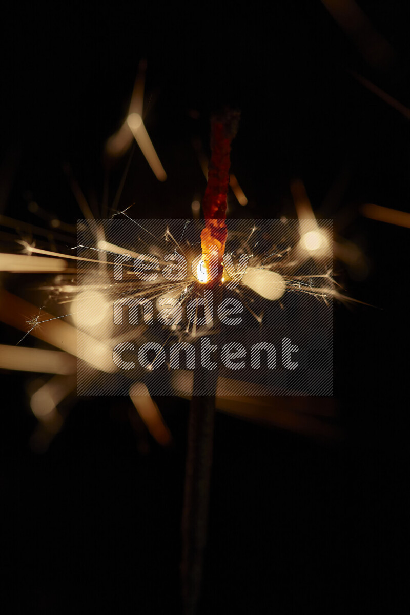 A close-up image of sparkler candle isolated on black background