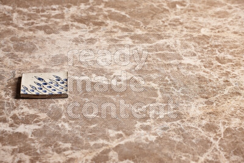 A decorative coaster on beige marble background