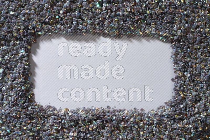 Multicolored flat sequins on grey background
