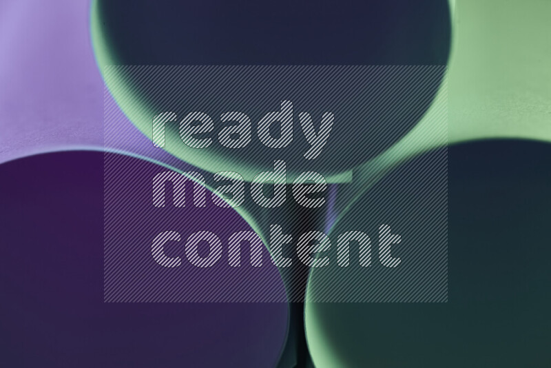 The image shows an abstract paper art with circular shapes in varying shades of green and purple