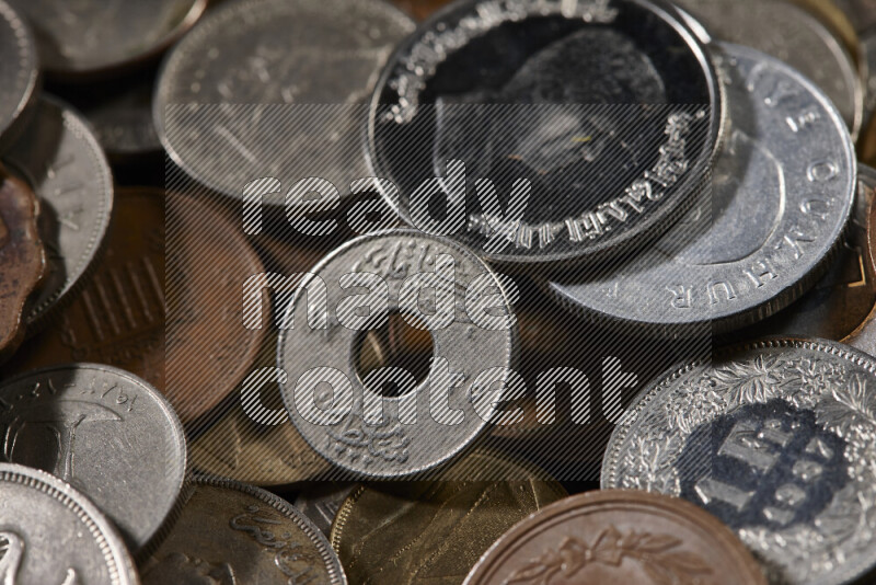 A close-ups of random old coins on black background