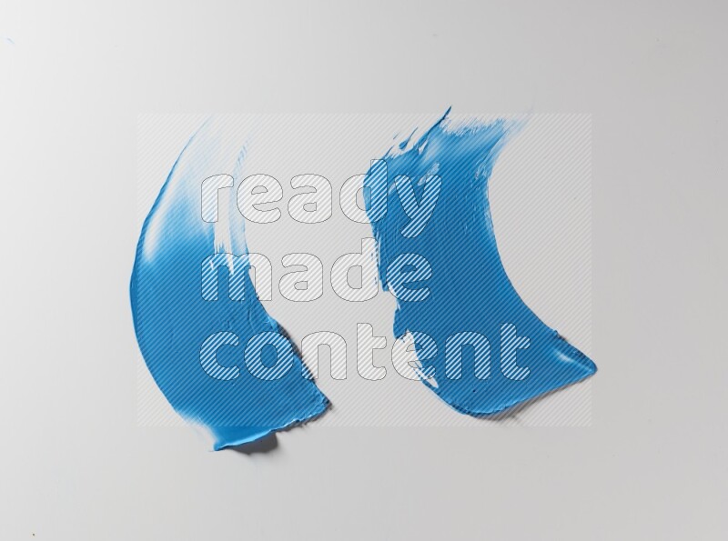 Blue curved painting knife strokes on white background