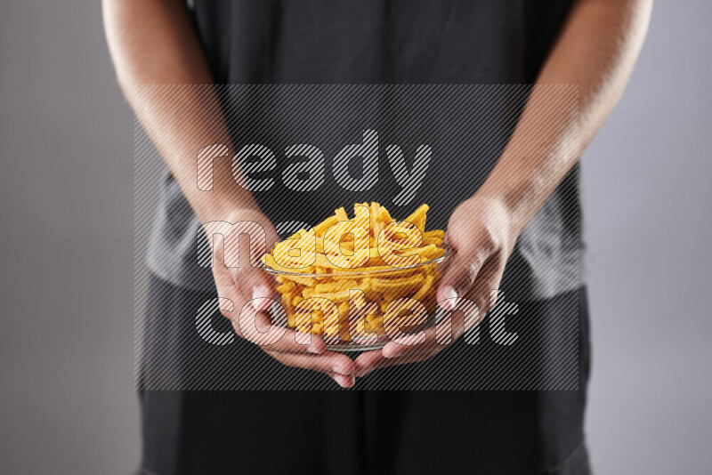 Woman in abaya holding different kinds of snacks in different positions