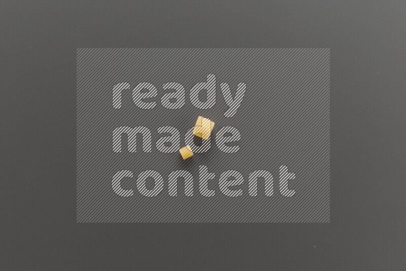 Small rings pasta with other types of pasta on grey background