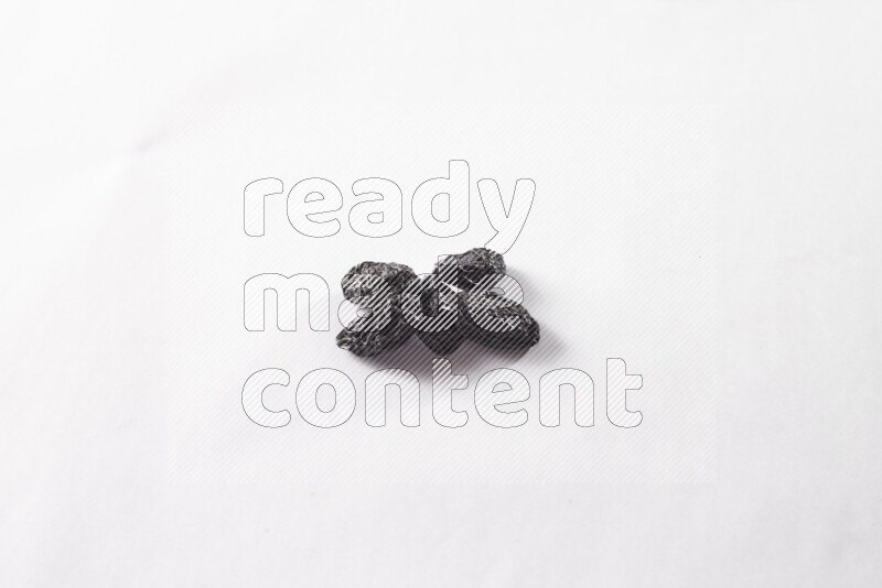 Dried plums on white background