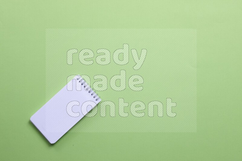 A blank open notebook on green background