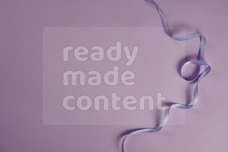 A purple collection of sewing and tailoring tools arranged on a purple background