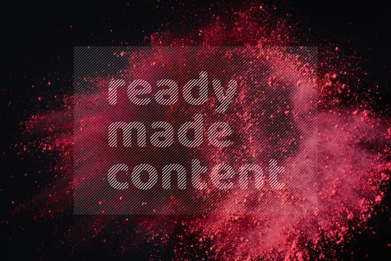 Red powder explosion on black background