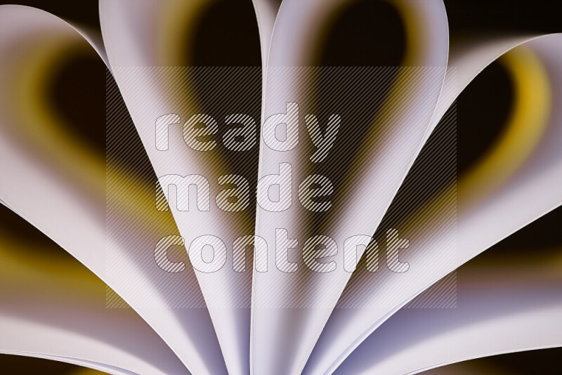 An abstract art piece displaying smooth curves in white and yellow gradients created by colored light