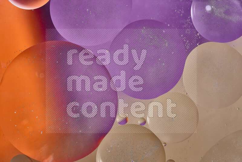 لقطات مقربة لفقاعات من الزيت على سطح الماء باللون البني والبرتقالي والأرجواني