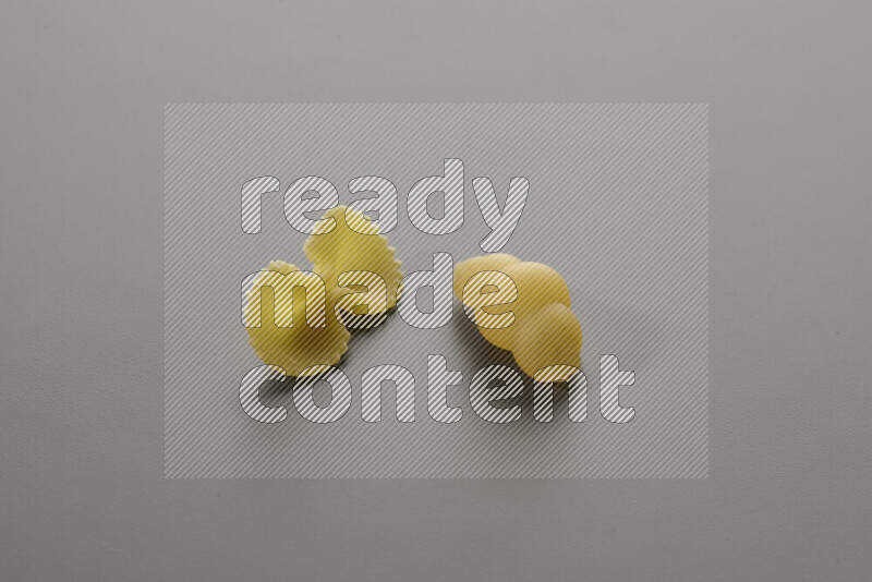 Fiocchi pasta with other types of pasta on grey background