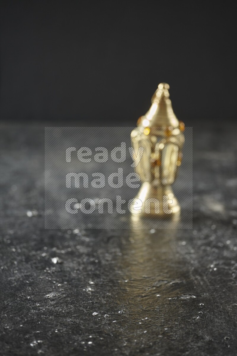 An out of focus lantern on textured black background