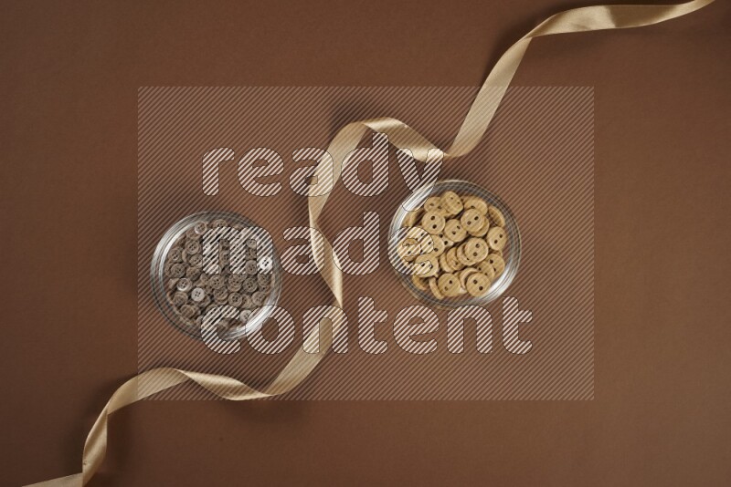 A brown collection of sewing and tailoring tools arranged on a brown background